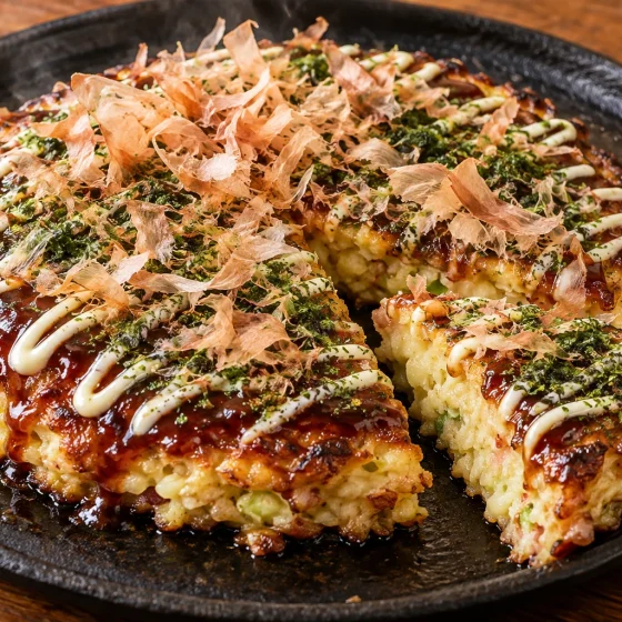Osaka-style okonomiyaki with sauce, Japanese mayonnaise, aonori and bonito flakes