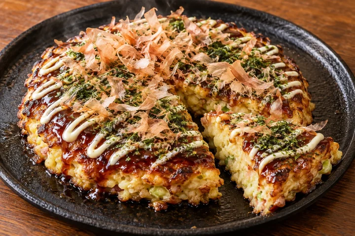 Osaka-style okonomiyaki with sauce, Japanese mayonnaise, aonori and bonito flakes